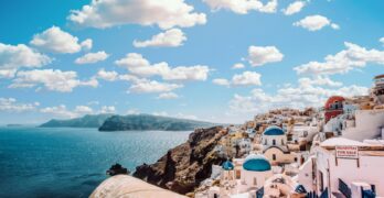 Captivating view of Santorini's famous blue-domed buildings under a vibrant sky.