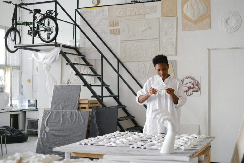 A skilled female artisan working with ceramics in a creative studio environment.