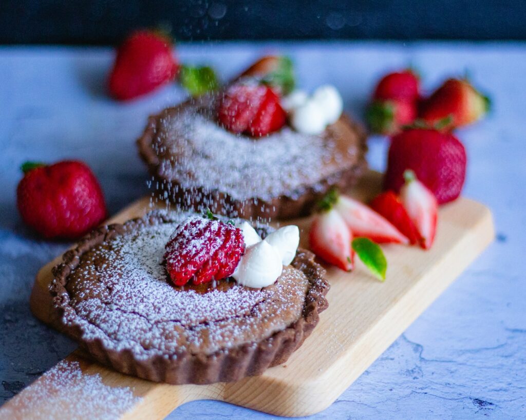 brown and white cake with strawberry on top