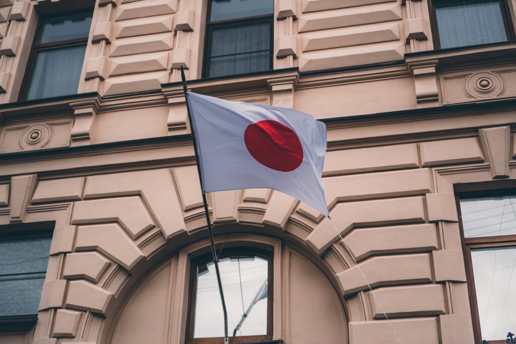 white red and black flag on brown concrete building during daytime