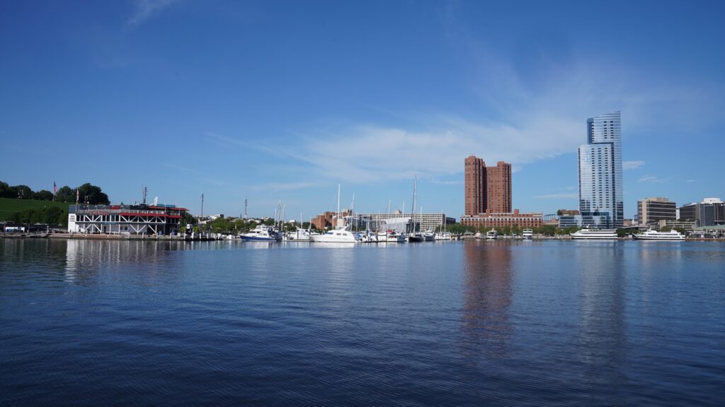 A body of water with a city in the background