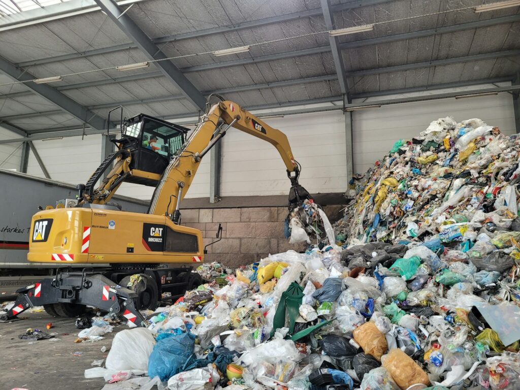 A large pile of trash sitting inside of a building