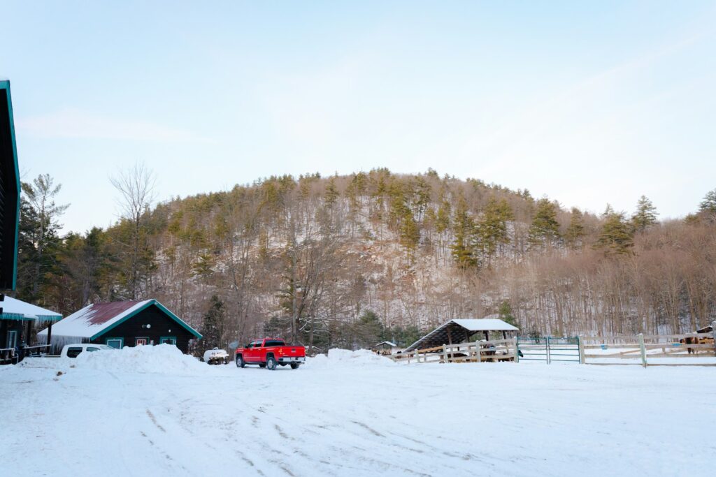 A snow covered field with a mountain in the background