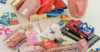 pink ceramic mug beside clear plastic container