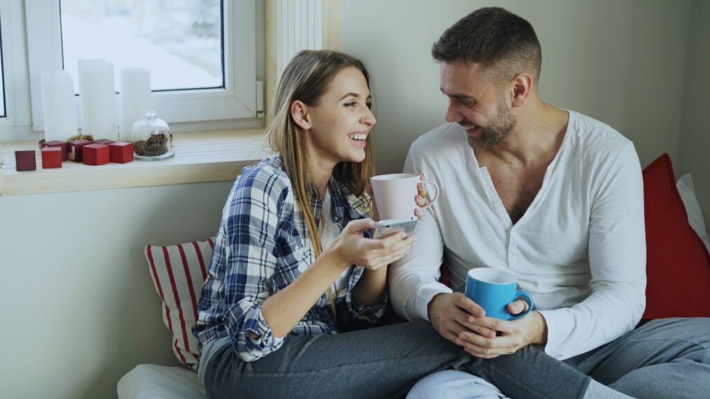 Couple enjoying coffee together by the window