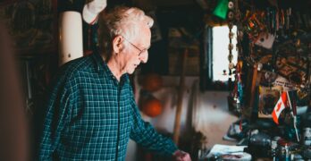 a man standing in front of a table filled with assorted items