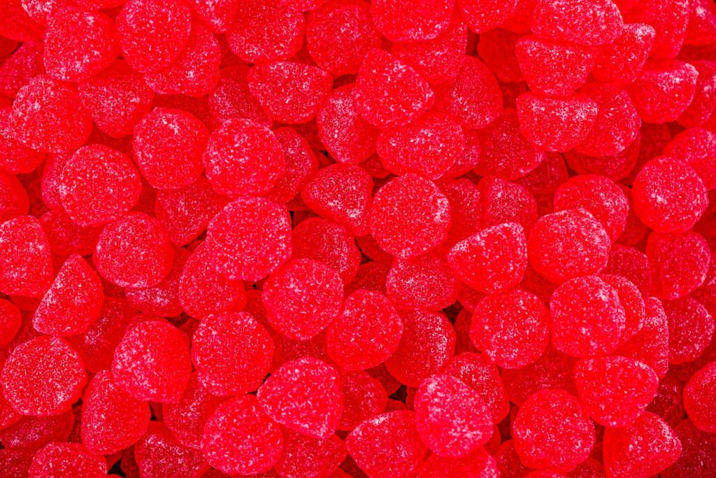 a close up of a pile of red candy hearts