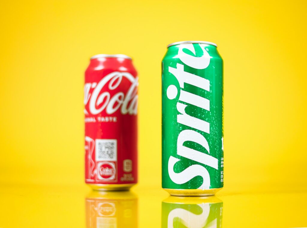 a couple of soda cans sitting on top of a table