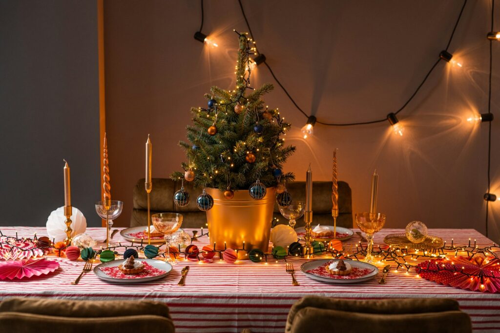 a table with a christmas tree and plates and glasses on it