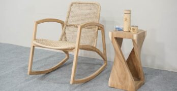 a wooden rocking chair next to a wooden table