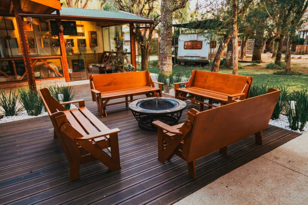 Inviting wooden benches encircle a fire pit on a deck, ideal for evening gatherings.