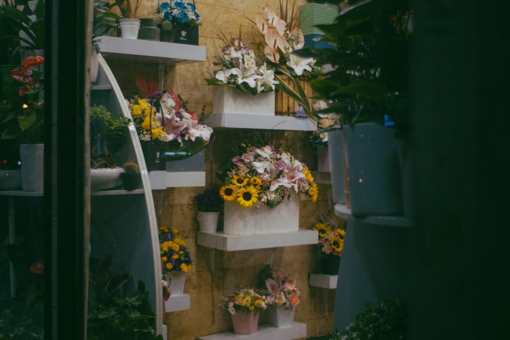 Assortment of colorful flowers displayed on shelves.