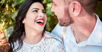 man and woman beside plant