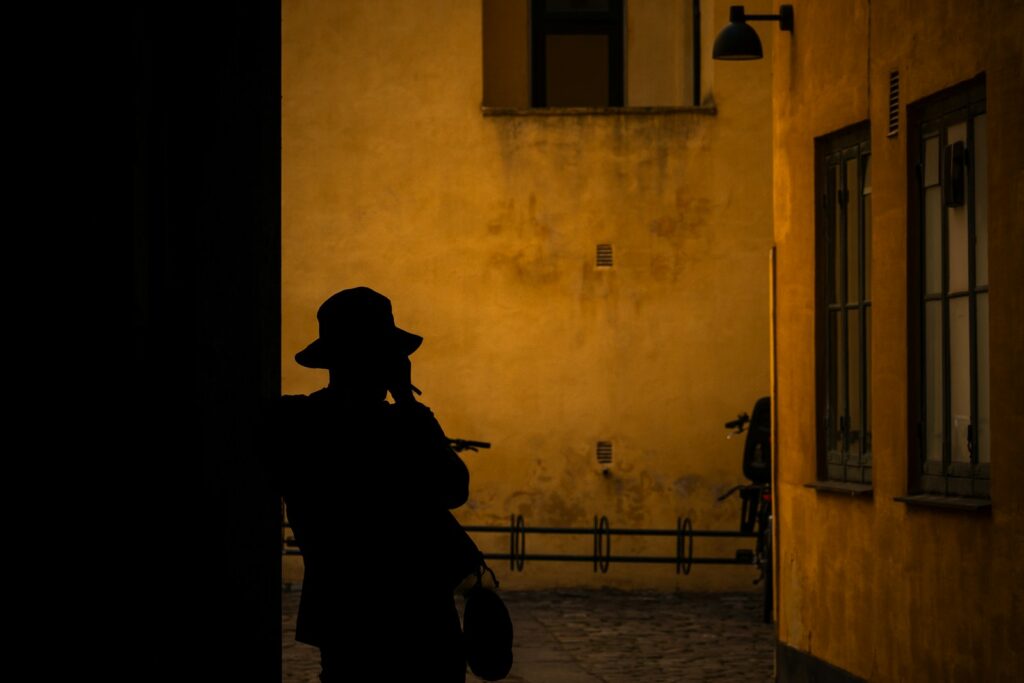 A person walking down a street at night