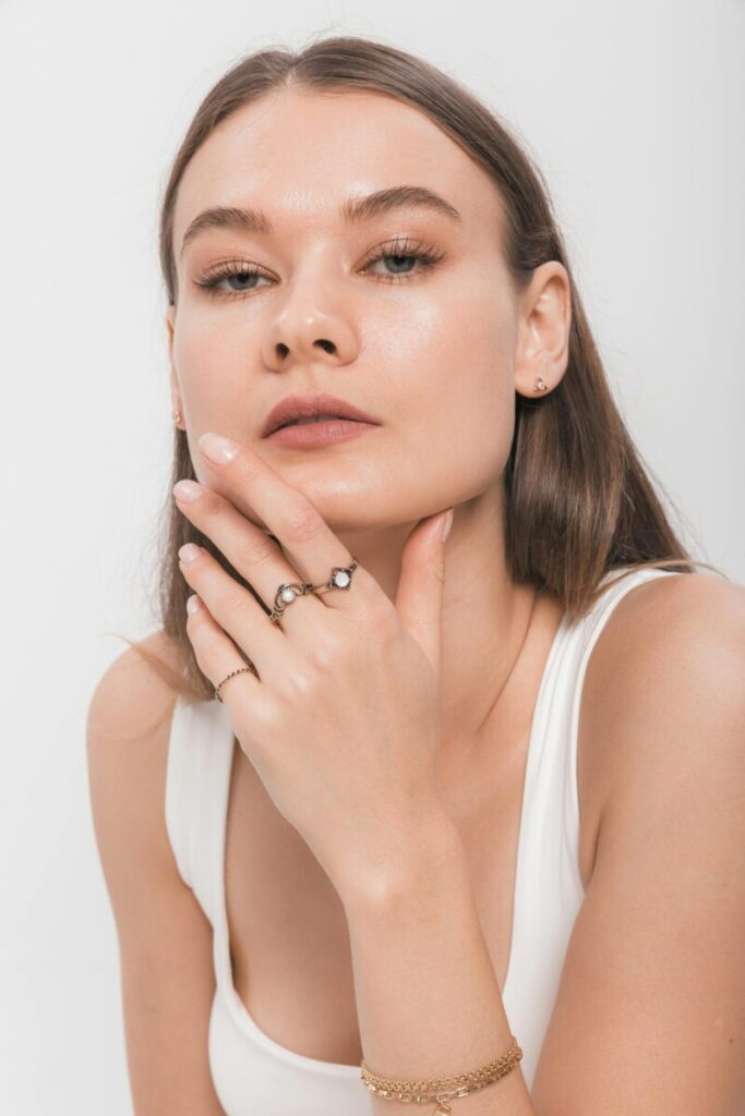 Close-up portrait showcasing minimalist jewelry with elegance and style.