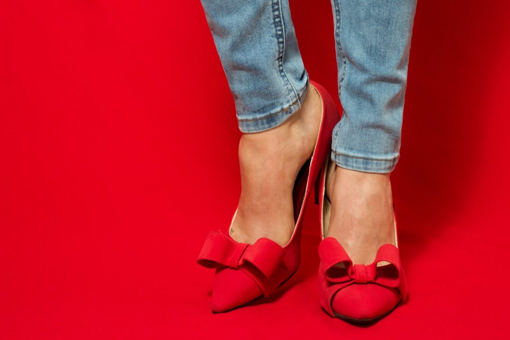 Woman wearing red high heels with bows