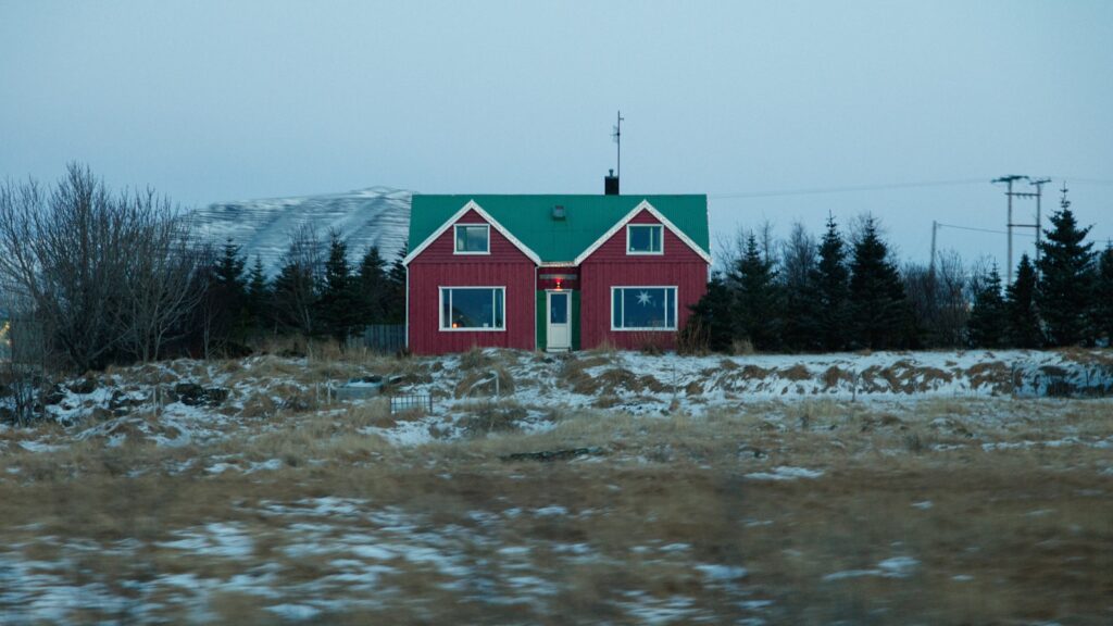 Red house sits peacefully in the winter landscape.