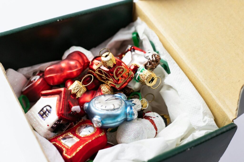 A close-up of vibrant Christmas ornaments stored in a box, perfect for festive decoration.