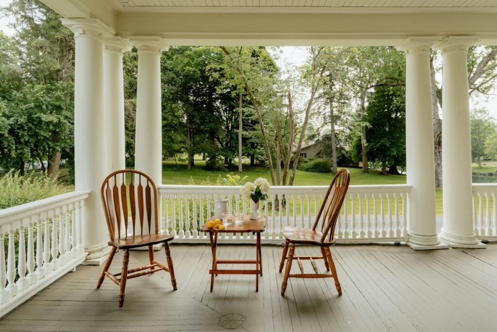 Two chairs and a table on a porch