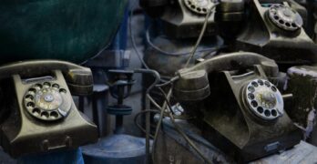 Close-up of vintage rotary telephones with a nostalgic feel, captured indoors.