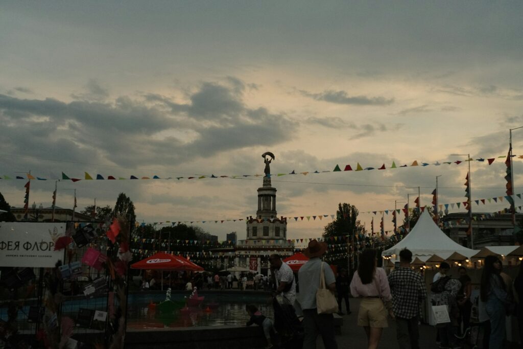 A fair or festival is happening outdoors at dusk.