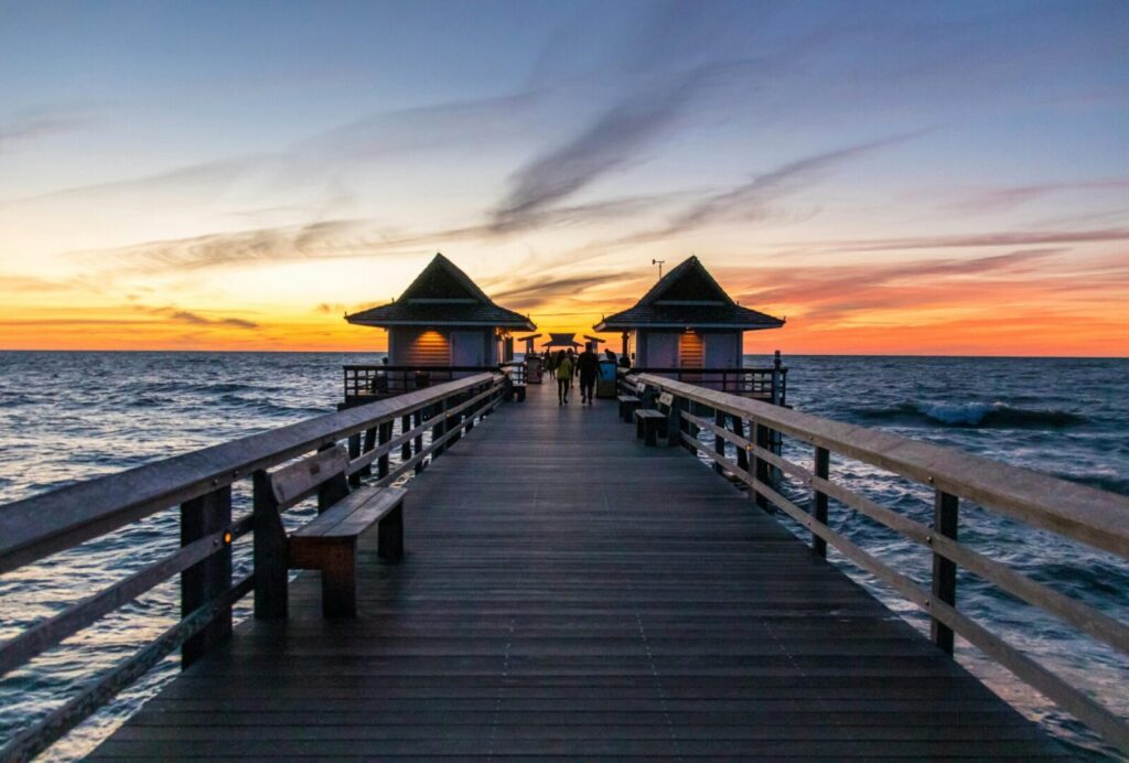Captivating sunset view from Naples Pier, Florida; a serene ocean landscape.