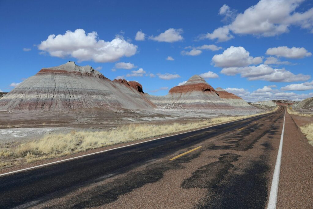 Stunning view of Painted Desert formations alongside a road in Petrified Forest National Park, Arizona.