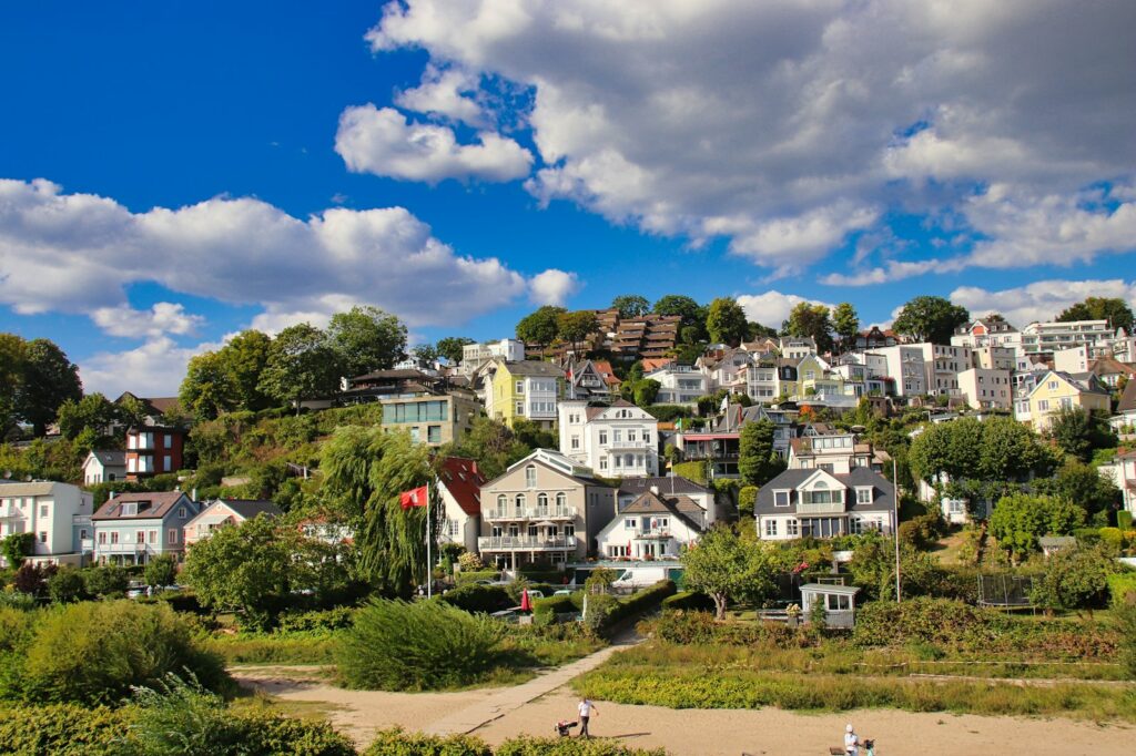a group of houses sitting on top of a lush green hillside