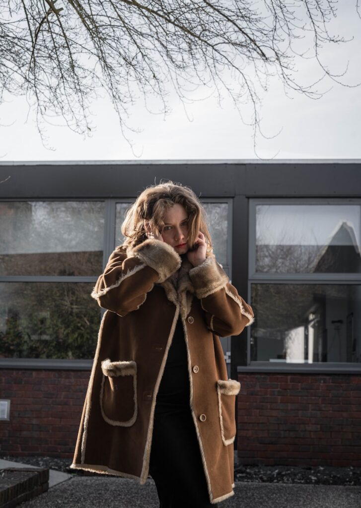 a woman walking down a street while talking on a cell phone