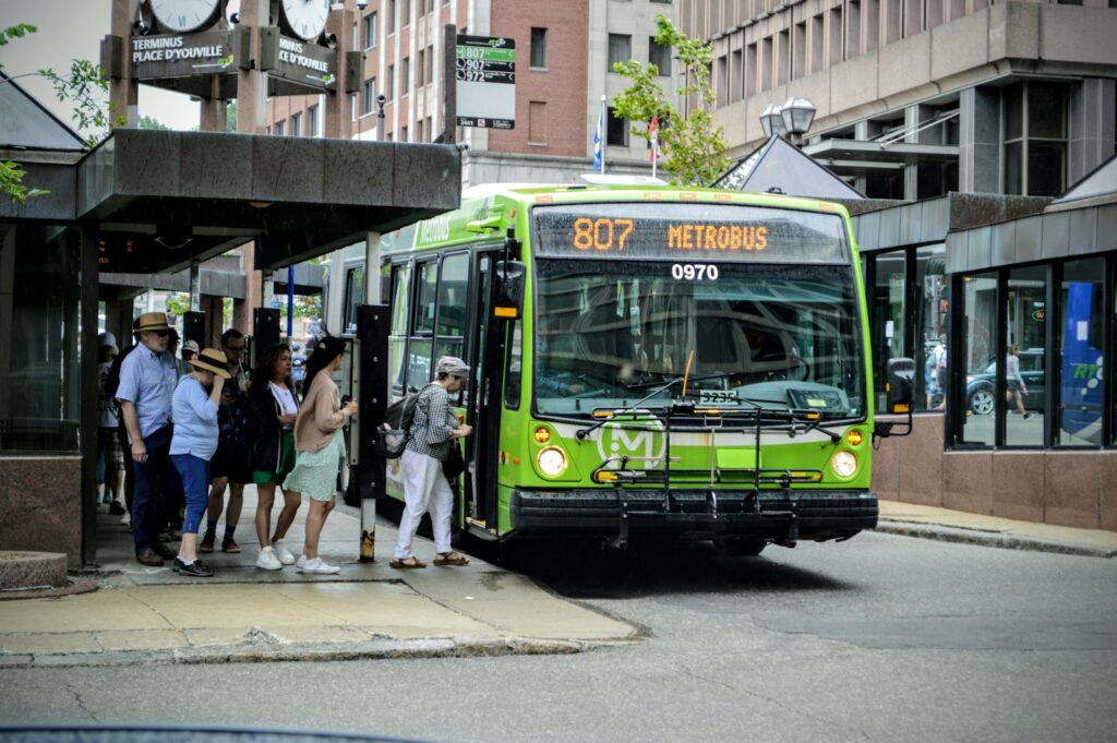 a group of people boarding a bus at a bus stop