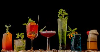 a table topped with lots of different types of drinks