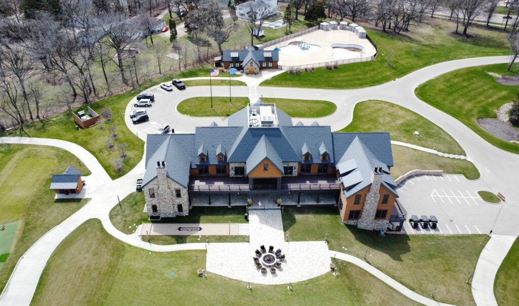 an aerial view of a house with a large driveway