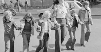 a group of young girls walking down a street