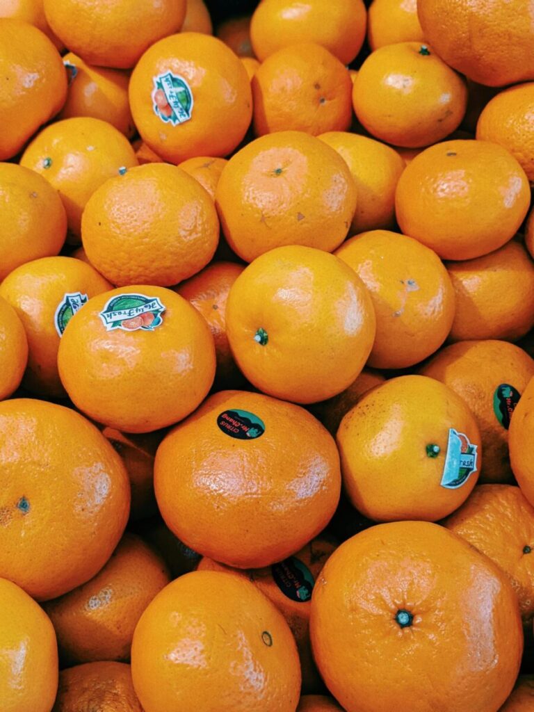 A vibrant display of fresh oranges at a market in Malang, East Java, Indonesia.
