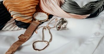 round white and gold-colored analog watch with gold-colored milanese band