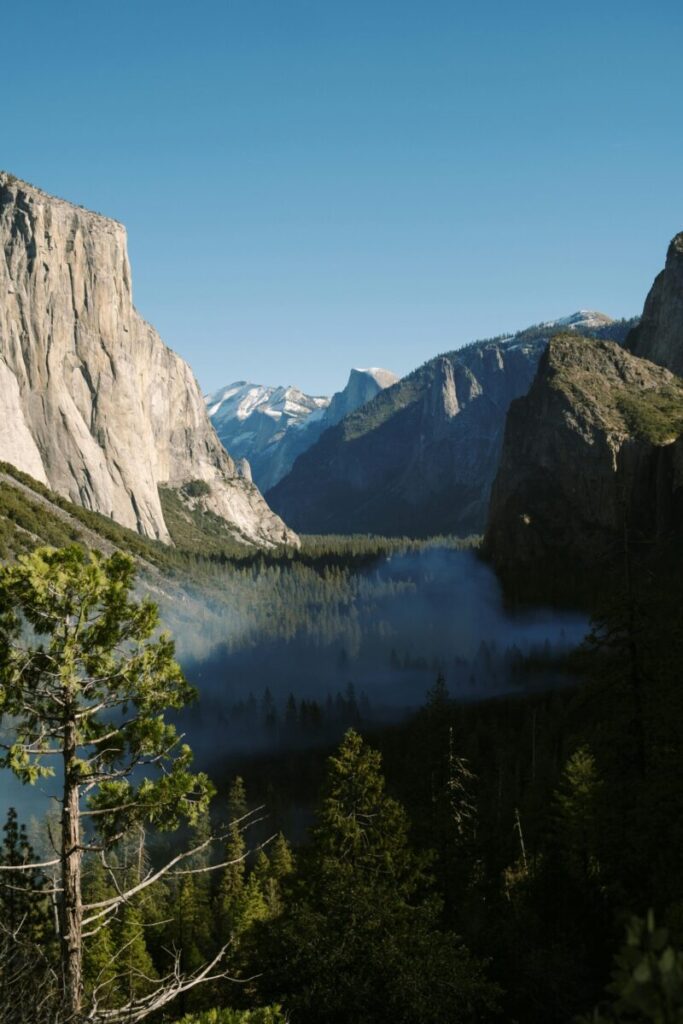 Breathtaking perspective of Yosemite Valley with iconic rock formations under a clear blue sky.
