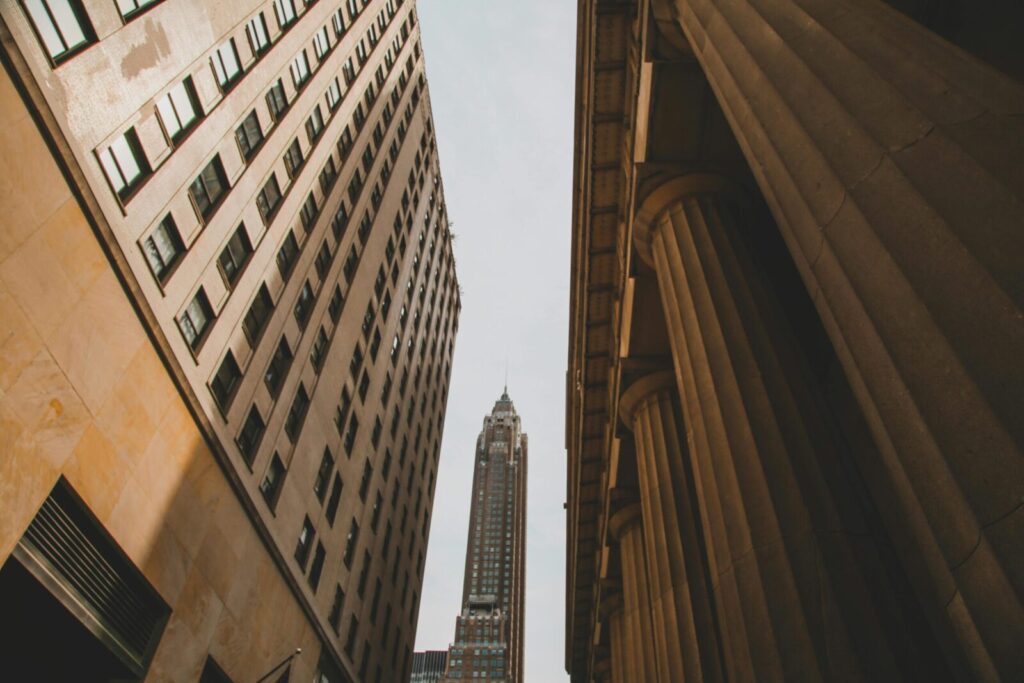 Street-level view of iconic skyscrapers and classic architecture in New York City.