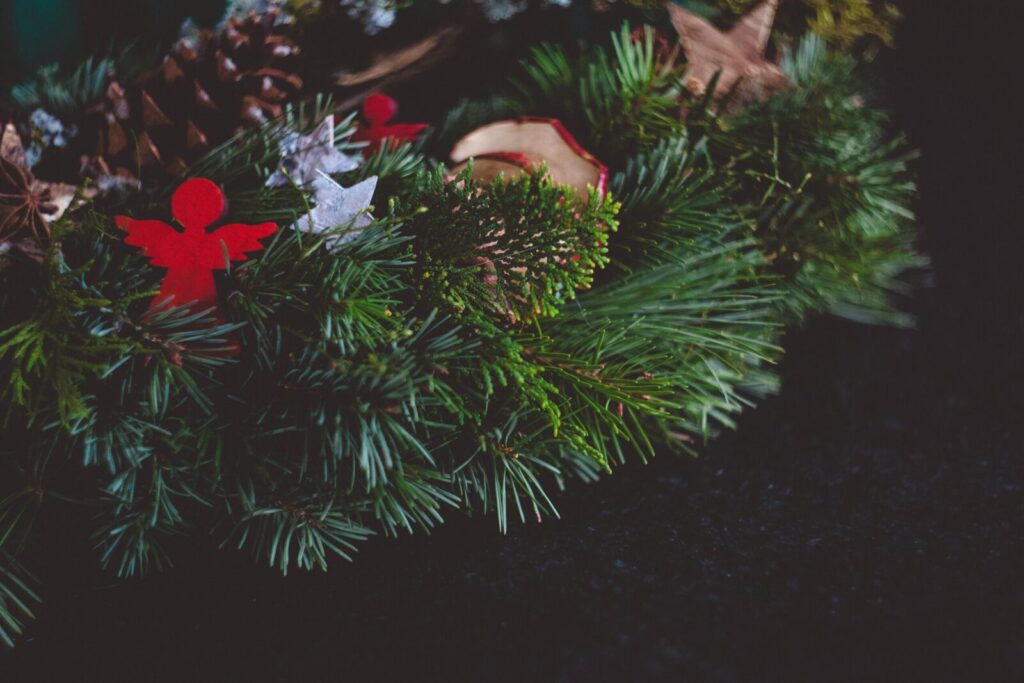 A traditional Christmas wreath adorned with pinecones and festive ornaments.