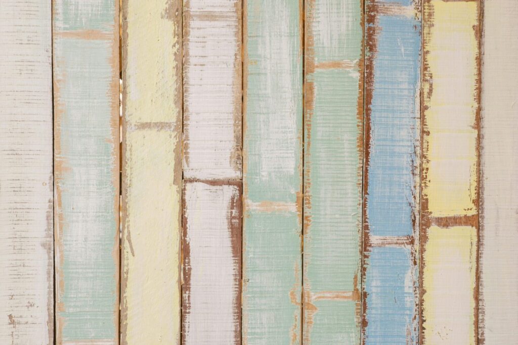 Pastel-colored wood planks background with rustic texture, ideal for design projects.