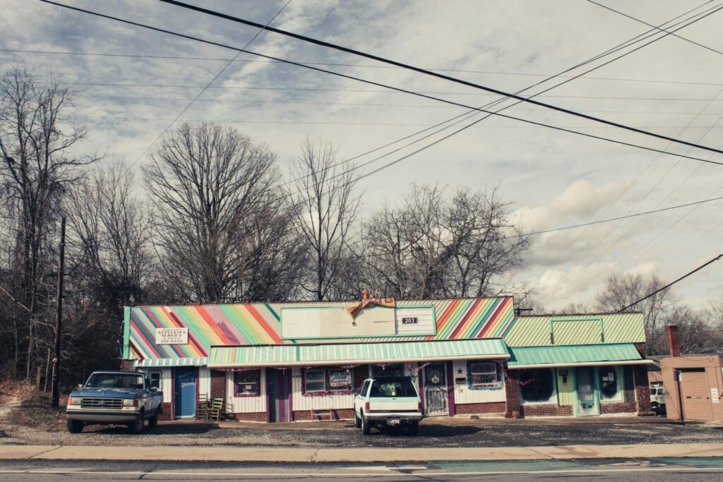 Vibrant storefront with vehicles and power lines in Asheville, NC