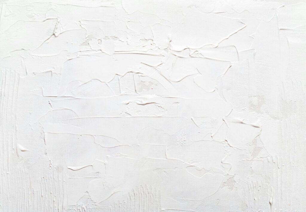 Close-up of a textured and painted white abstract surface, ideal for backgrounds.