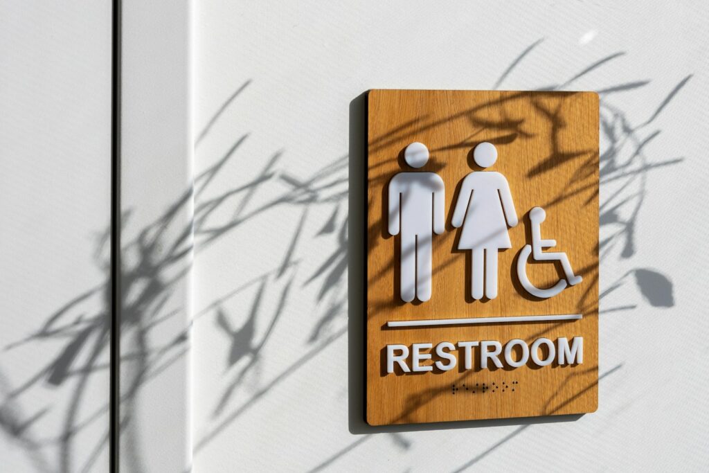 a restroom sign on the side of a building