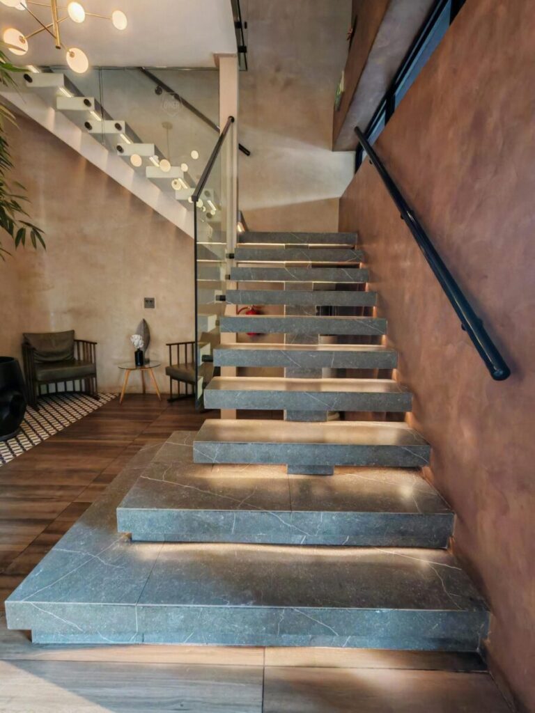 A stylish indoor staircase made of stone, located in a contemporary home in Krugersdorp, South Africa.