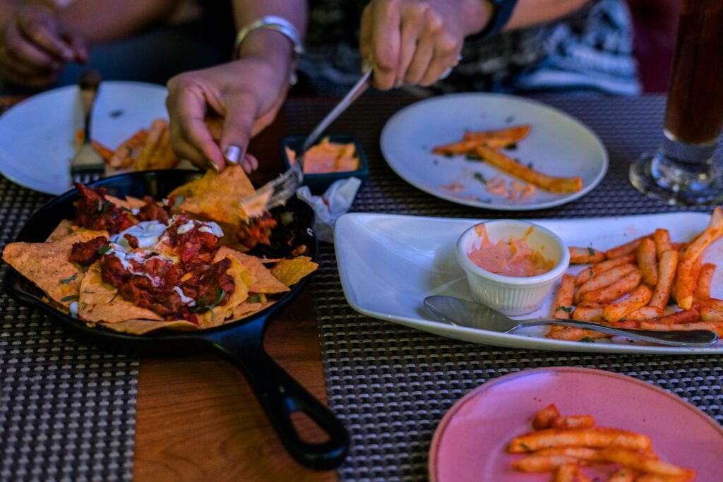 a person cutting up food on a plate