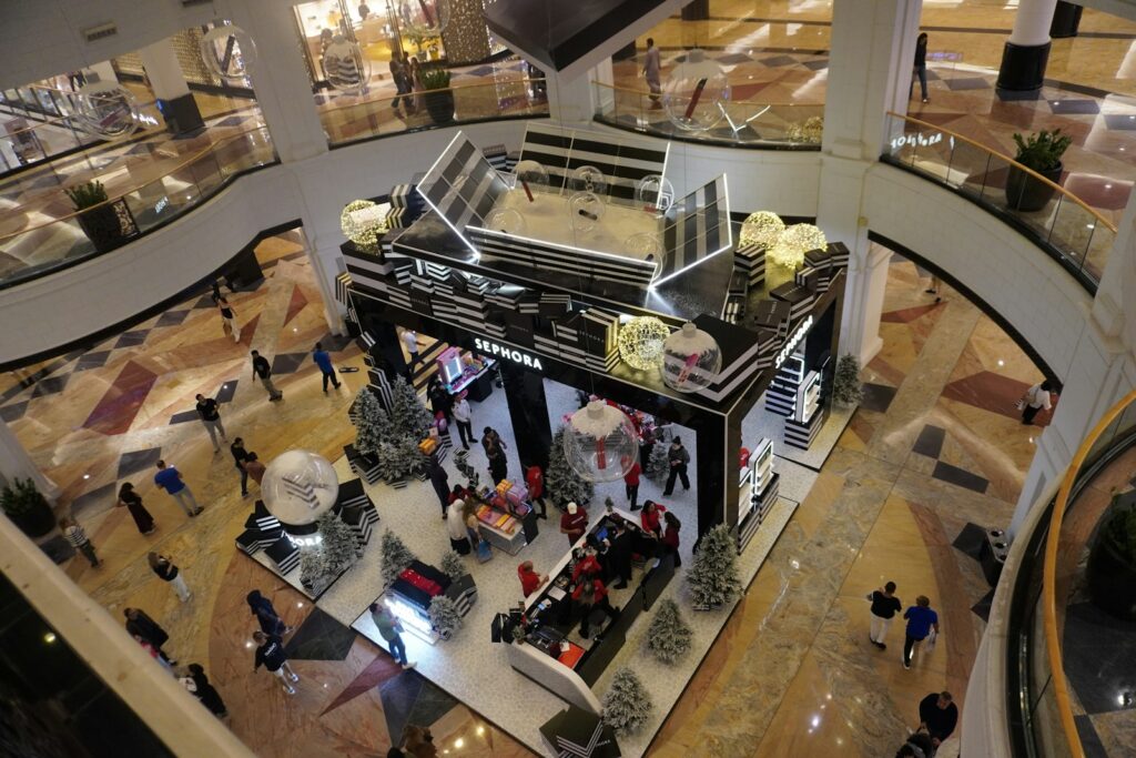 People shopping in a modern, multi-level mall.