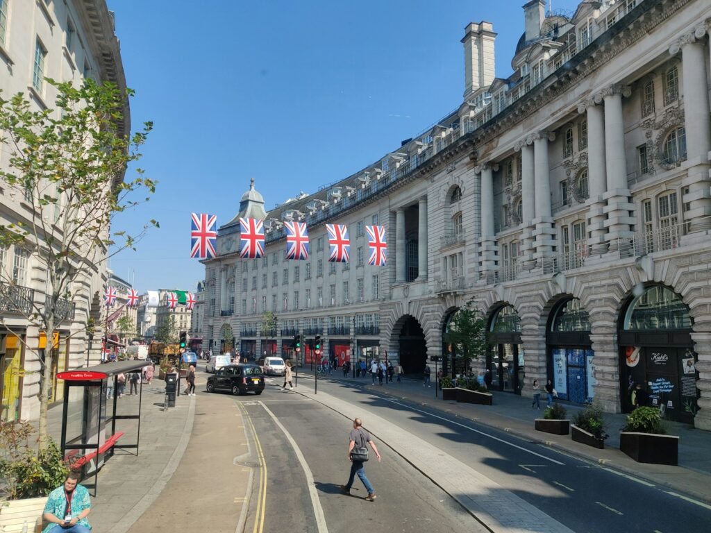 a person walking down a street in front of a building
