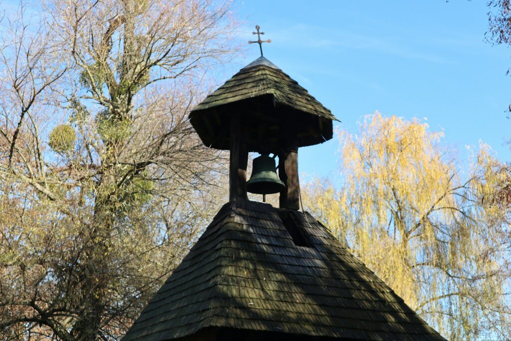 A bell tower with a cross on top of it