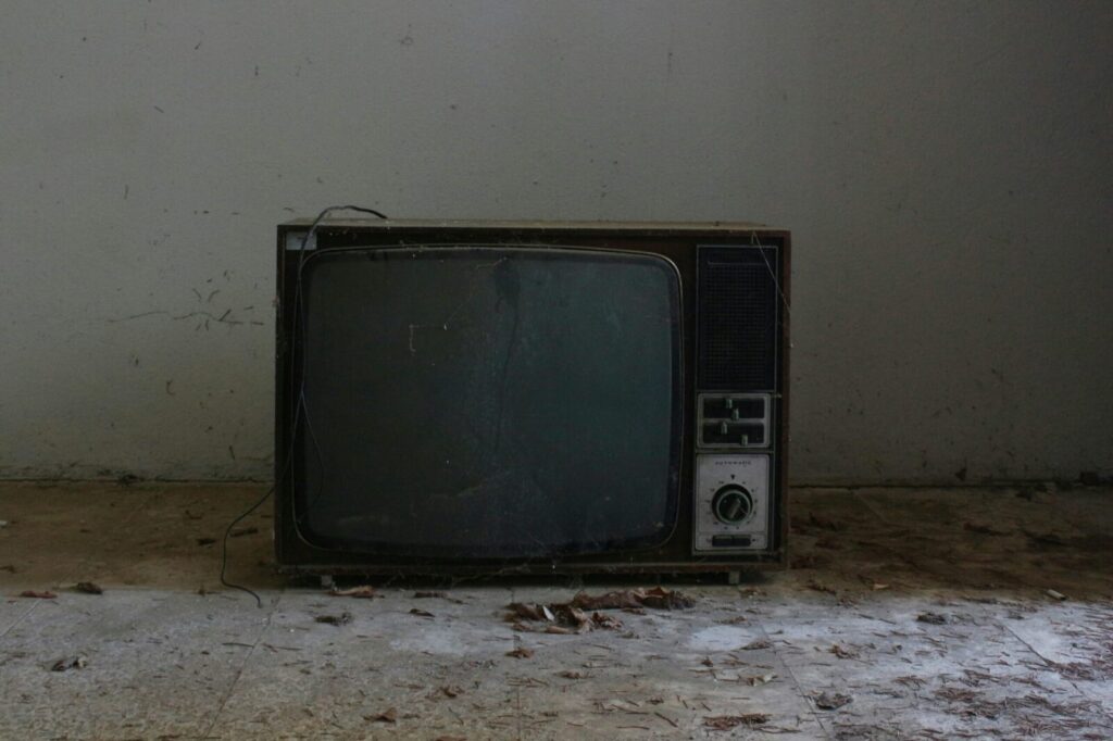 Old retro TV set in a deserted room, evoking nostalgic vibes.