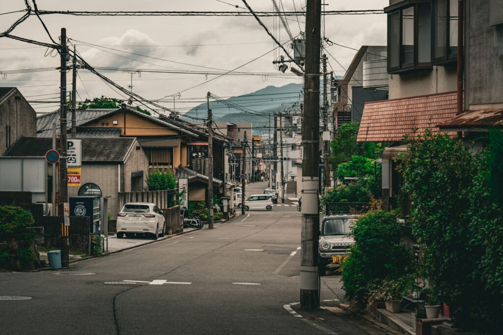 A city street lined with houses and power lines