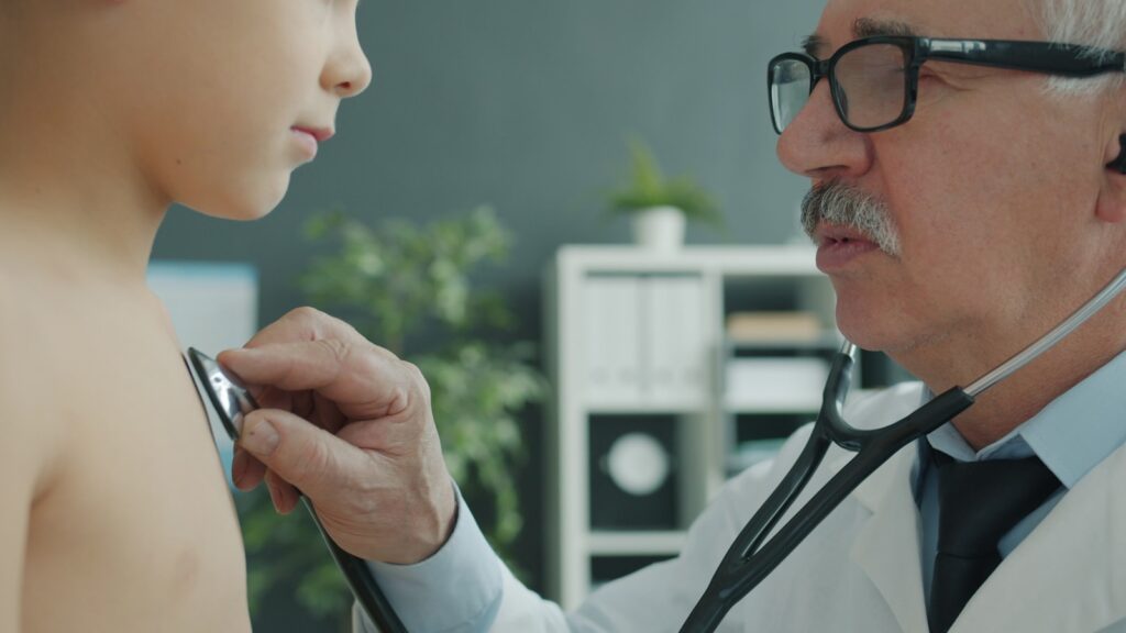 Doctor examines child's chest with stethoscope